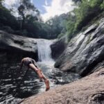 best travel photographer in wayand a man jumbed a small river