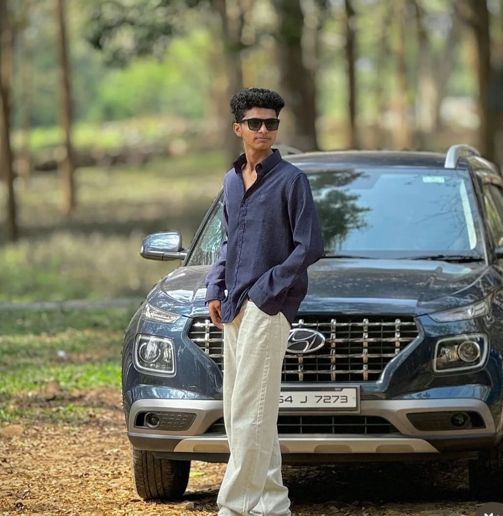 best travel photographer in wayanad a man standing in a car