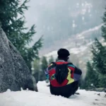 best travel photographer in wayanad the man siting to snow